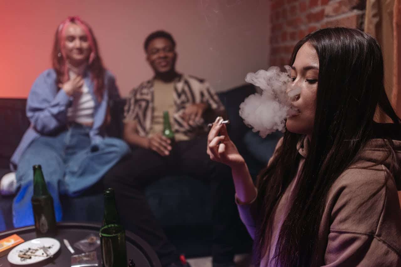 Person Smoking Weed At Party With Friends